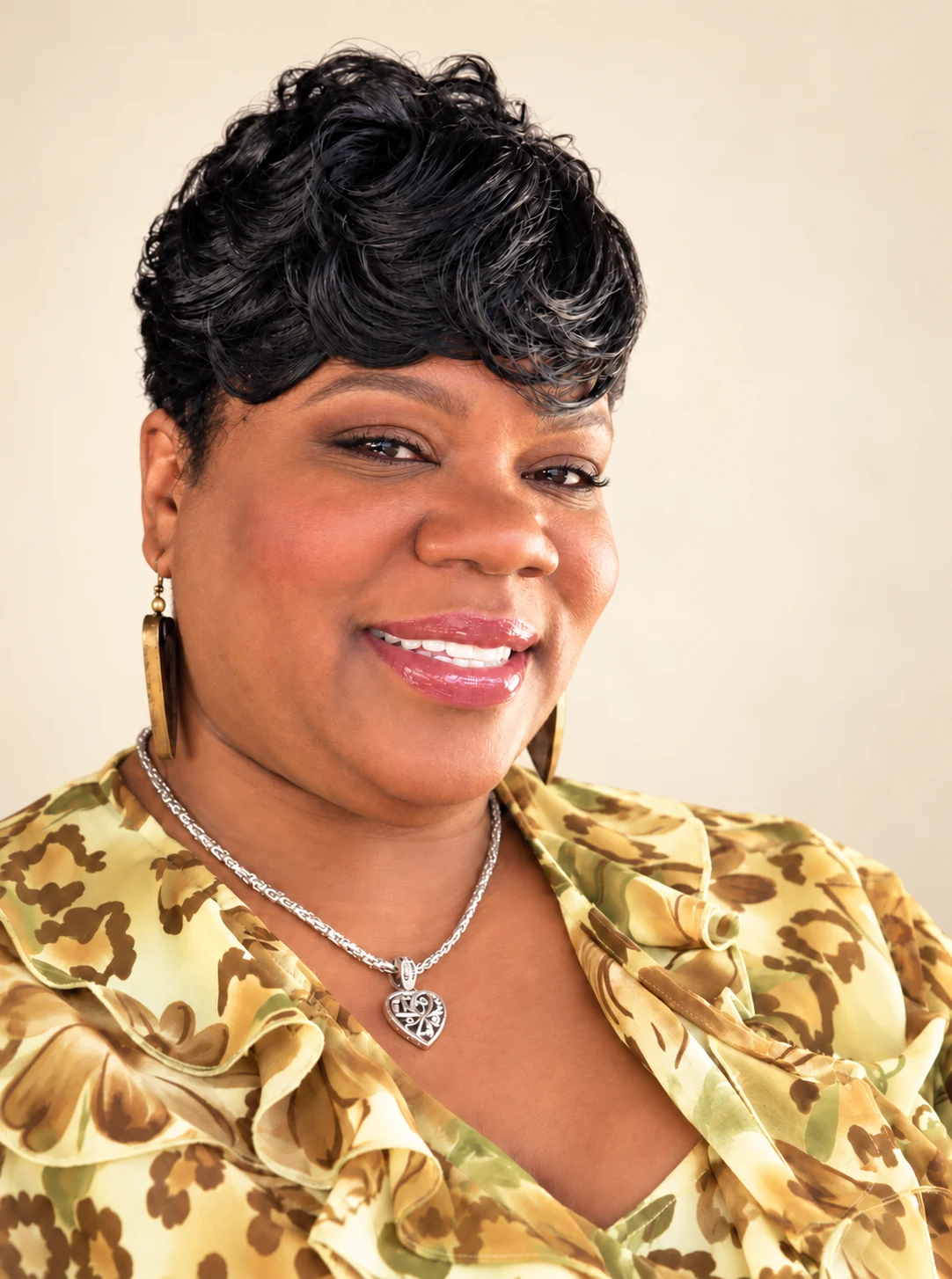 Portrait of Tashona S. Whyte against a warm cream background